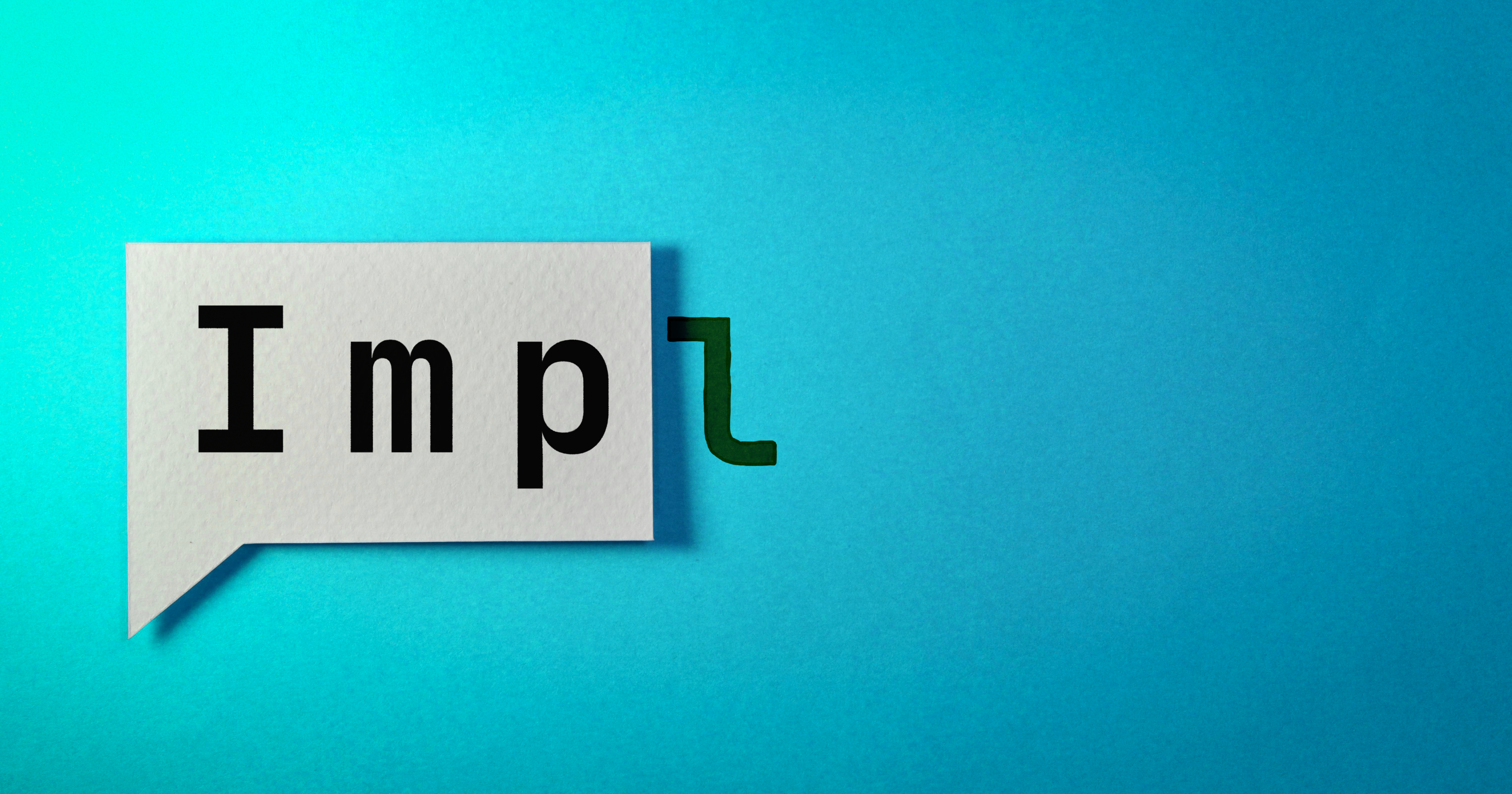 The word 'Imp' written on paper, with an 'l' overflowing off the edge